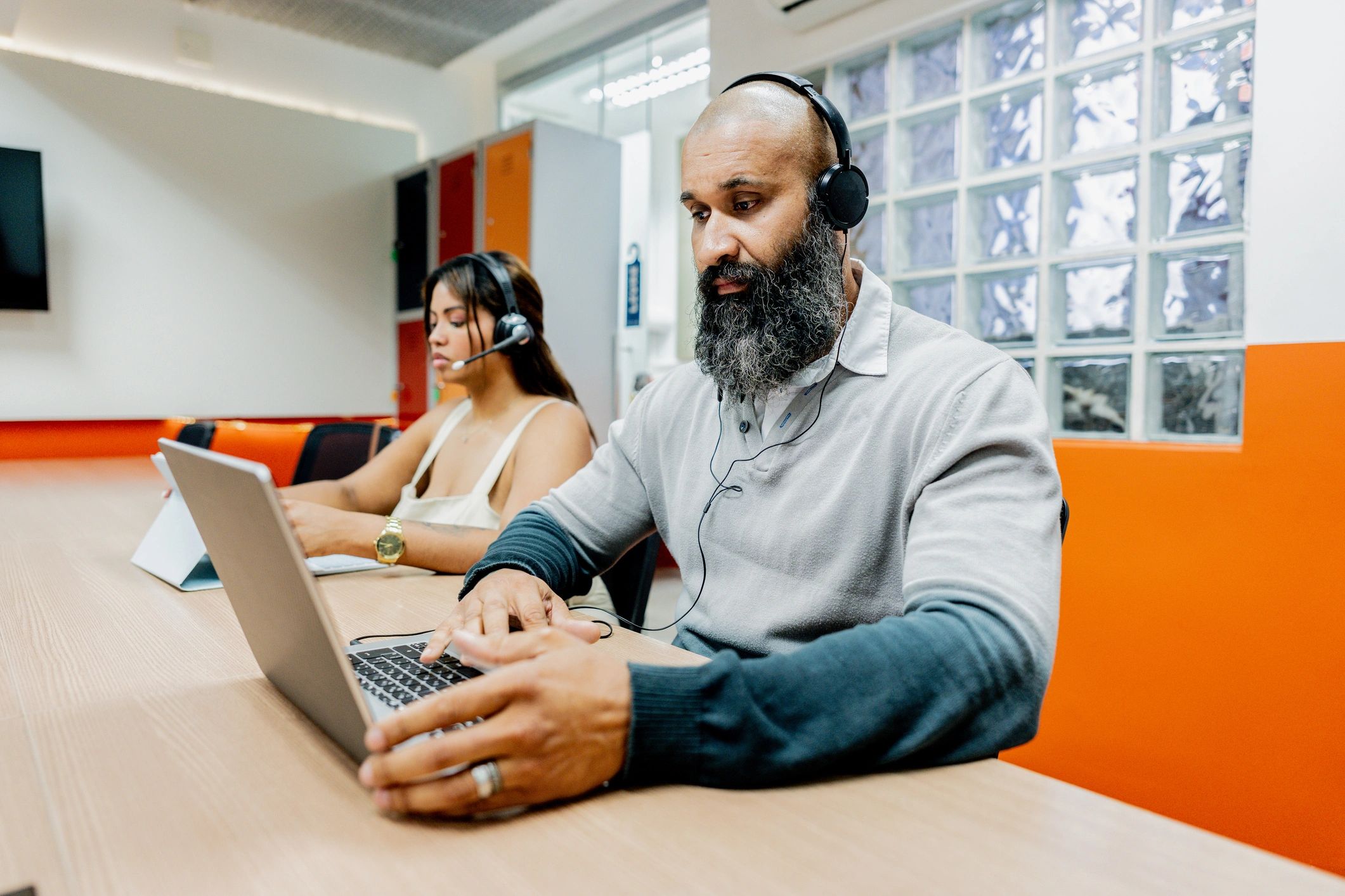 Customer service representative wearing a headset at a desk